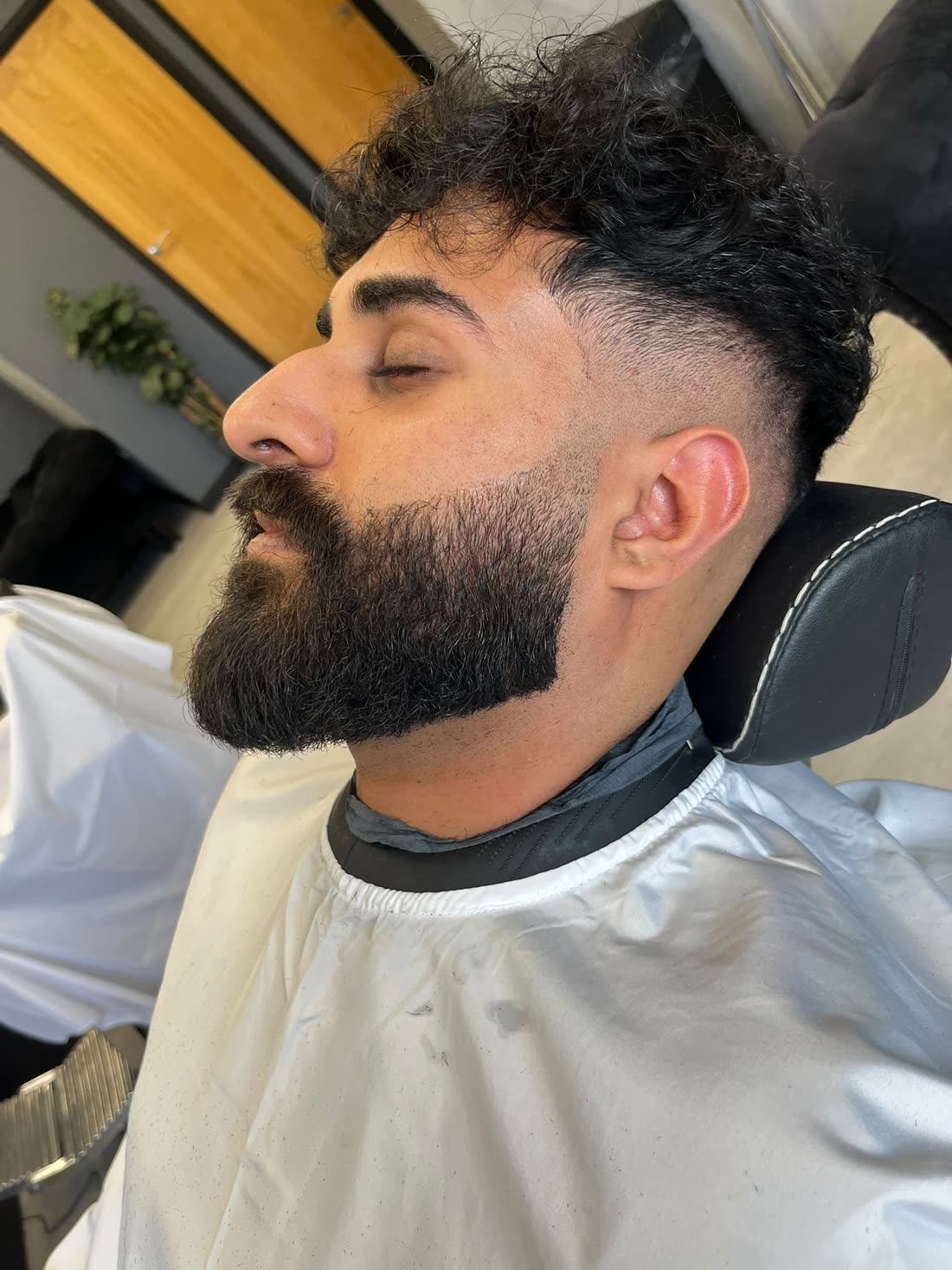 Sharp beard line up with mid fade and dark curls — barbering at STANDRD, Leamington Spa